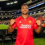 Francis Ngannou in a Man. Utd Jersey