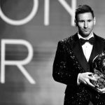 Lionel Messi with a Ballon d'Or award