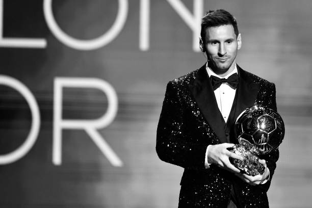 Lionel Messi with a Ballon d'Or award